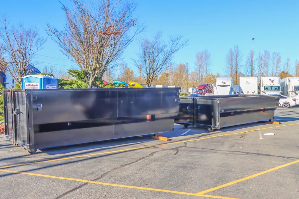 Professional dumpster rental service with roll-off container on residential driveway in Kerman